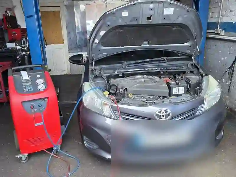 A grey Toyota having an air-con service inside the M&A MOT workshop