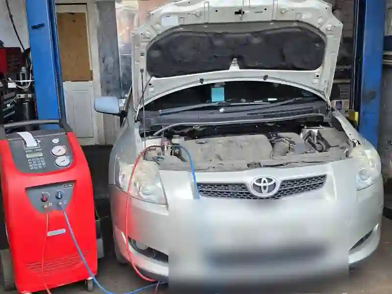 A silver Toyota being serviced at M&A MOT & Repair Centre
