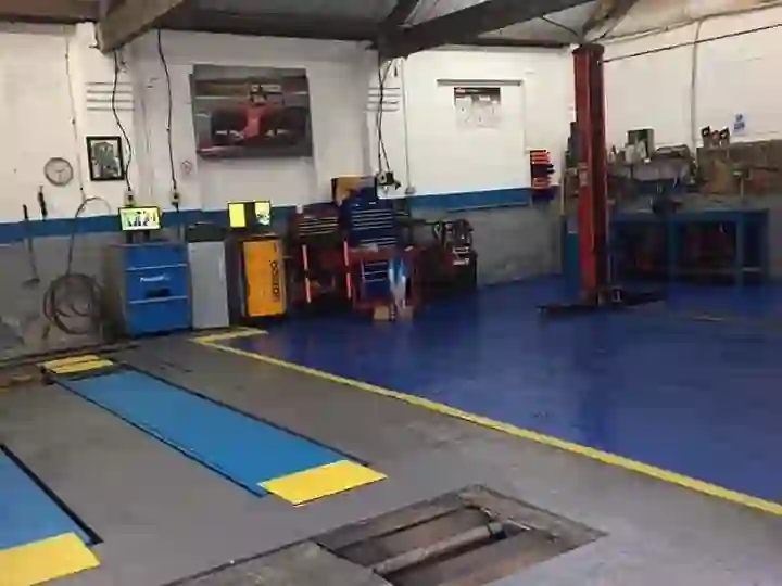 Inside the M&A MOT & Repair Centre workshop on Bishop Street, Rochdale — the MOT bay and vehicle lift